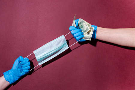 gloved hands, money, medical mask. Flatlay. Top view. Coronavirus pandemic. The concept of the struggle for survival. Place for text.の写真素材
