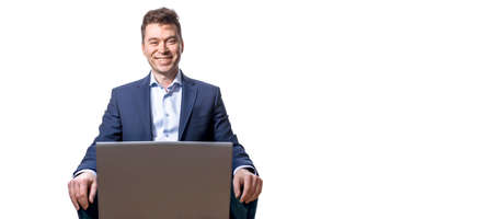 Portrait of a smiling man wearing a business suit using laptop computer, home office during quarantine. coronavirus pandemic. Self isolation. Remote work. Copy space. Isolated on a white background.の写真素材