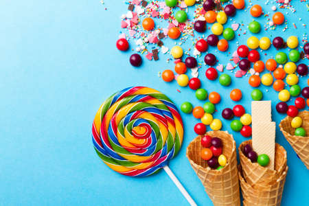 Tasty appetizing Party Accessories Happy Birthday Sweet Treat Swirl Balloon Candy Lollypop Colorful Letters on Bright Background Top View Fashion Conceptual Holiday Flat Layの写真素材