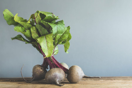 Fresh beetroot placed on wooden table behind gray background. Concept of natural, eco, organic,...