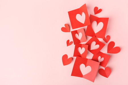 Beautiful valentines day paper hearts on pink background. View from above. Valentines Day Concept.