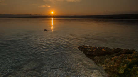 Sunset during evening across the sea.の写真素材
