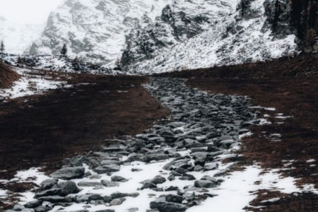 The snow on the mountains . The lake with water.の写真素材