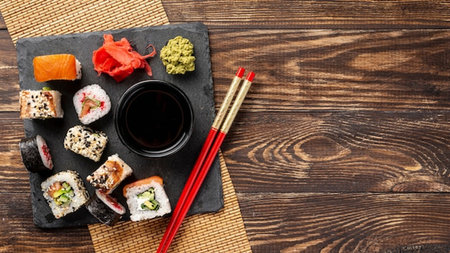 Sushi set on wooden table with chopsticks and soy sauce. Top view with copy spaceの写真素材