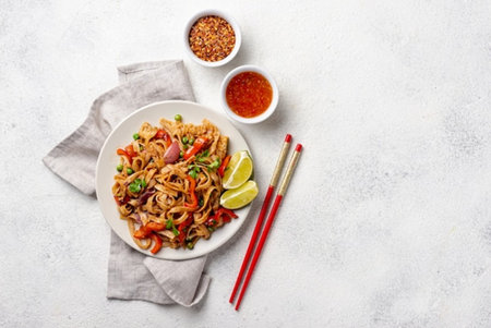 Stir fry noodles with vegetables and meat on white background. Asian food