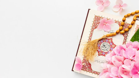 Holy Quran and pink hydrangea flowers on white background.の写真素材