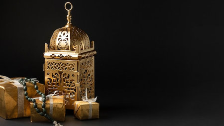 Golden lantern and gift boxes on black background. Ramadan Kareem concept.の写真素材