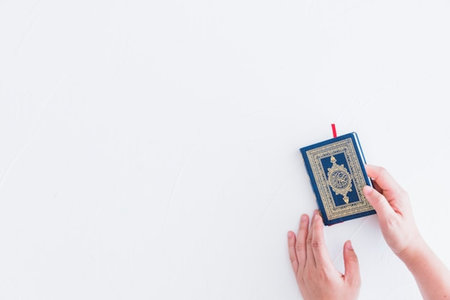 Hands holding holy quran on white background with copy space.の写真素材