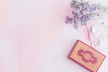 Holy Quran, beads and lavender flowers on pink background. Ramadan Kareem concept.の写真素材