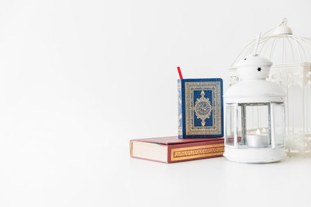 Holy Quran and lamp on white background. Ramadan Kareem concept.の写真素材
