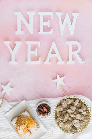 New Year greeting card. Top view flat lay with copy space on pink backgroundの写真素材