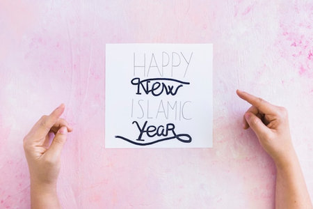 HAPPY NEW YEAR message written on white paper on pink background