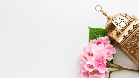Top view of golden lantern and pink hydrangea flowers on white backgroundの写真素材