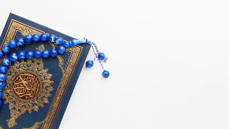 Holy Quran with rosary beads on white background. Ramadan Kareem concept.の写真素材