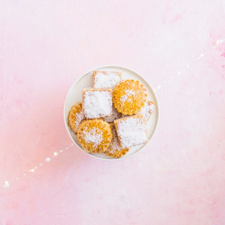 Coconut sugar cookies on pastel pink background, top viewの写真素材