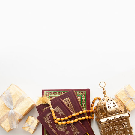 Muslim holy book Quran with rosary beads and gift boxes on white backgroundの写真素材