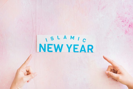 New Year or Christmas greeting card. Woman's hands hold a white paper with the text I am new year on a pink backgroundの写真素材