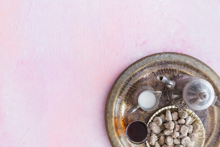 Traditional Turkish coffee in a copper tray on a pink background. Copy space.