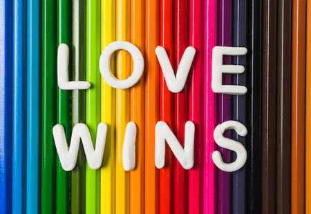 word love wins on an abstract background from multi-colored pencilsの写真素材