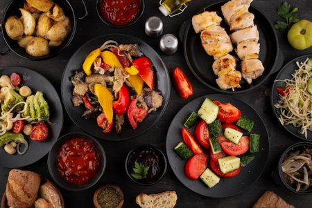 Top view of plate with different appetizers on dark wooden background.の写真素材