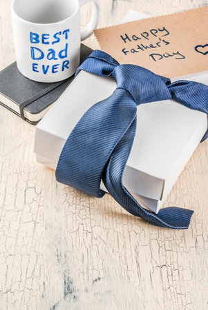 Father's day concept with a cup of coffee, books and gift box
