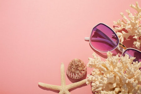 summer background with coral, sunglasses and starfish on pink backgroundの写真素材