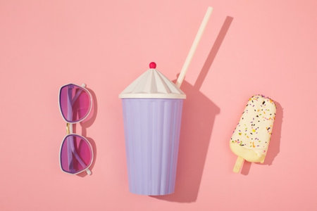 Summer concept. Ice cream and sunglasses on pink background. Flat lay, top viewの写真素材