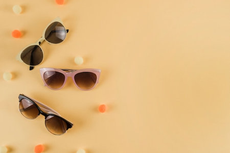 Sunglasses on pastel yellow background. Flat lay, top view.