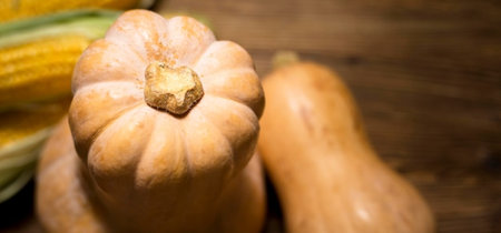 Pumpkin and corn on a wooden background. Selective focus.の写真素材