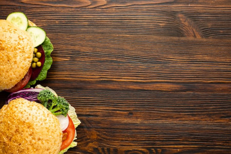 Homemade hamburgers on wooden background. Top view with copy spaceの写真素材