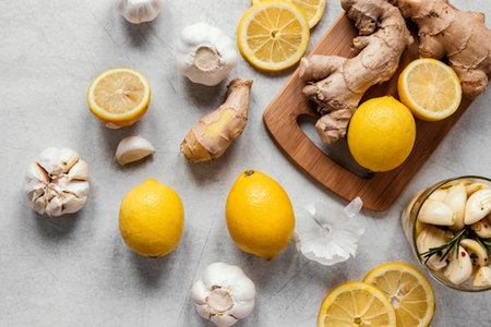 Ginger, garlic, lemon and rosemary on a light background