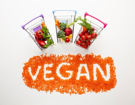 Vegan word made from red lentils and vegetables in shopping cartsの写真素材