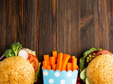 Hamburger and ingredients on wooden background. Top view with copy space