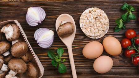 Ingredients for cooking oatmeal porridge with mushrooms and vegetables on a wooden background, top viewの写真素材