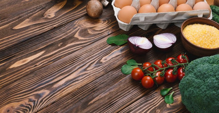 Healthy food background. Fresh organic vegetables and eggs on wooden tableの写真素材