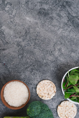Healthy food concept. Rice, spinach, broccoli on concrete background. Top view, copy spaceの写真素材
