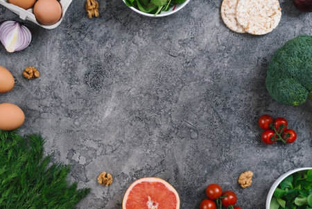 Healthy food background. Fresh vegetables, fruits and nuts on stone table. Top viewの写真素材
