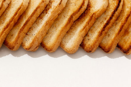 Close up of a stack of toasted bread on white background.の写真素材