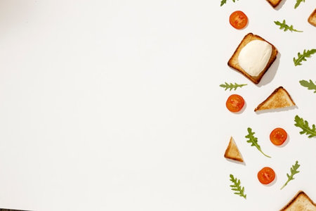 Sandwiches with cheese, tomatoes and arugula on a white backgroundの写真素材