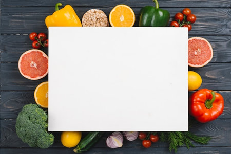 Healthy food background. Top view of fresh vegetables, fruits and empty paper sheet on wooden tableの写真素材