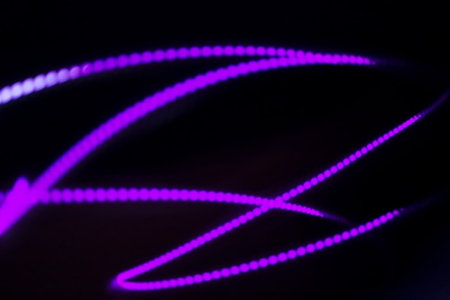 Neon lines on a black background. Abstract background with bokeh effect.の写真素材