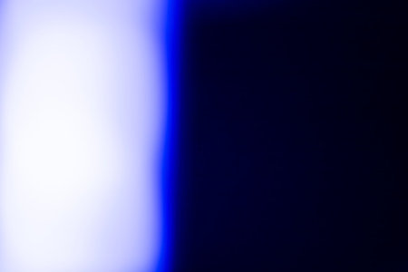 Abstract blue background with bokeh defocused lights and shadow.