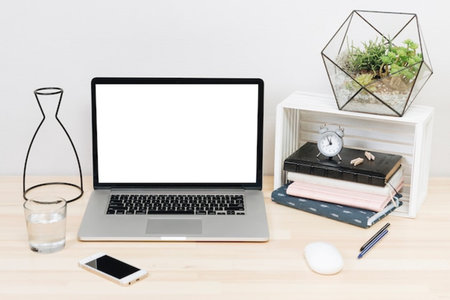 Laptop computer with blank screen on wood table and coffee cup, stock photo