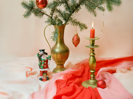 Christmas still life. Christmas composition of fir branches, candle and toy snowman. Artistic blur の写真素材