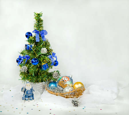 Christmas still life with snow. Toy Santa Claus is standing under a Christmas treeの写真素材