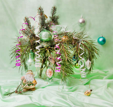 Christmas composition of fir branch decorated with balls and toy Santa Claus. Artistic blurの写真素材