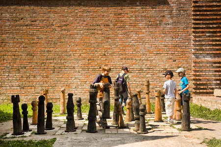 Lutsk, Ukraine - June 01, 2011:  Childrens enjoying a game of chess at High Castle. Lutsk High Castle began its life in the mid-14th century as the fortified seat of Gediminas' son Lubartのeditorial素材
