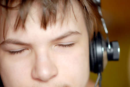 Portrait of a young boy who is listening to music in his headphonesの写真素材