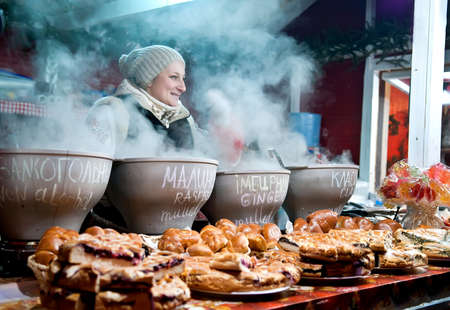 Kyiv, Ukraine - Jan 8, 2017: Woman sell mulled wine at traditional Christmas market on Sophia Square in Kyiv.  There are many stalls selling gifts and also serving up seasonal food and drinkのeditorial素材