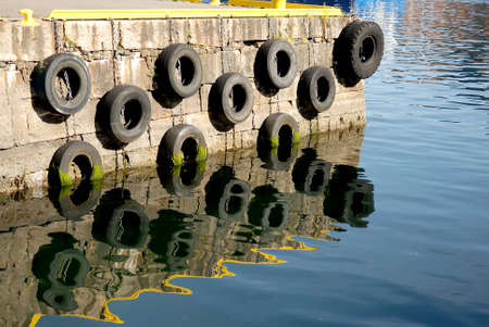Concrete pier, with hanging tire buffersの写真素材
